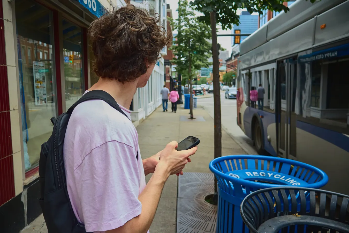 Waiting at a bus stop downtown